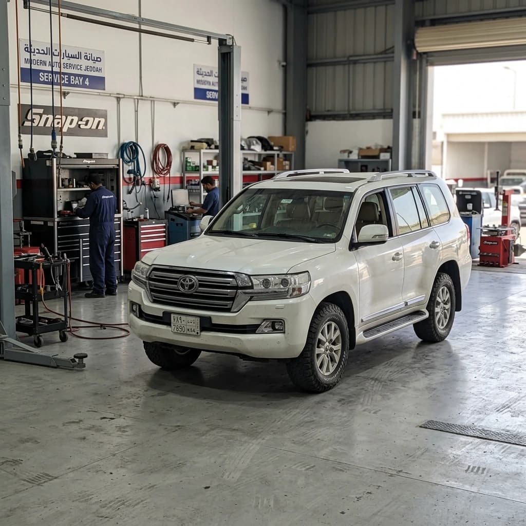 Toyota Land Cruiser parked inside modern maintenance bay in Jeddah